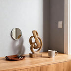 Abstract wood-toned knot sculpture, geometric decorative statue, wood-toned accent piece for living room coffee table or bookshelf surface, office TV cabinet or entryway console table decoration.