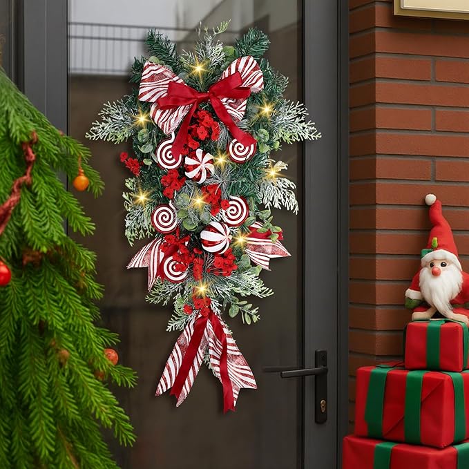 Yunlly 28" Pre Lit Christmas Teardrop Swag Battery Operated Christmas Swag with Lights, Red and White Bowknot, Swirl Candy Cane Ball, Xmas Wreath Ornament for Indoor Outdoor Front Door Decoration